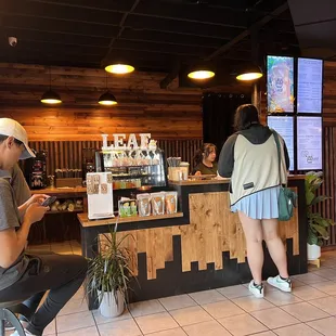 a man and a woman standing at the counter