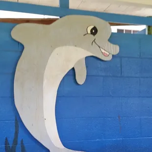 Cute mural on the wall outside of their pool.