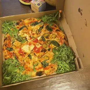 Large pizza, mozzarella, pepper mix, arugula, and basil