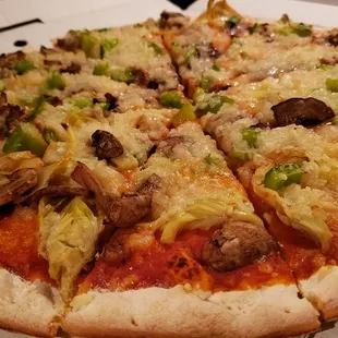 16" pizza w/vegan cheese &amp; 3 toppings ($29). Great thin crust. Cheese was either Violife or Glenview Farms.