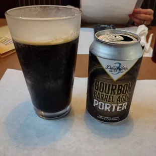 a glass of beer and a can of porter