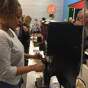a woman making a cup of coffee