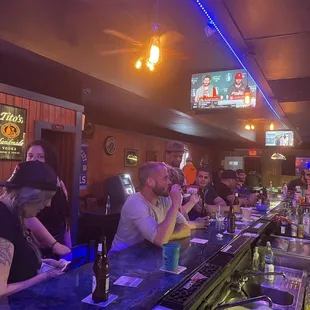 a group of people sitting at a bar
