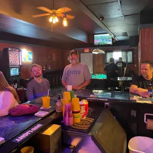 a group of people sitting at a bar