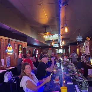 a group of people sitting at a bar