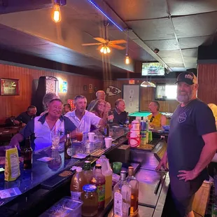 a group of people sitting at a bar