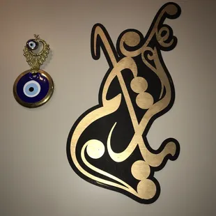 a black and gold emblem and a blue evil eye
