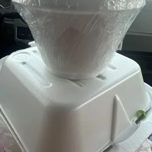 a plastic container on top of a plastic container