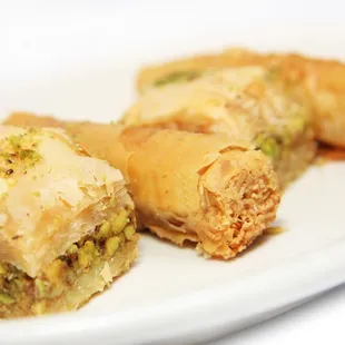 three pieces of baklaa on a white plate