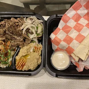 Lamb and beef platter with rice, baba ganoush, and pita.