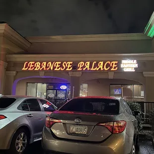 cars parked in front of a restaurant