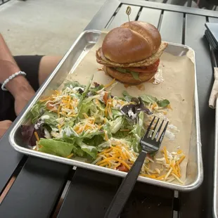 Spicy chicken sandwich and side salad