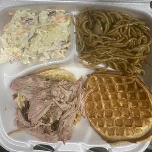 Pulled pork on a waffle bun with coleslaw and garlic noodles.