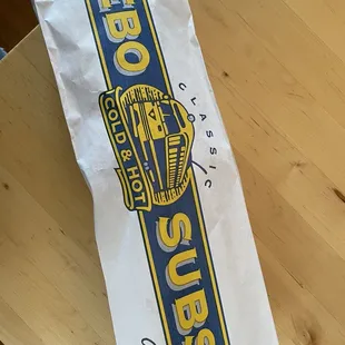 a bag of subs on a table
