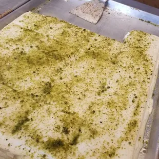a sheet of cake covered in pesto
