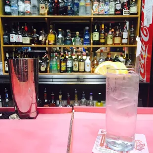 a cold drink with a lemon wedge