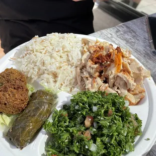 Platter: basmati rice, Tabouleh, chicken shawarma, Stuffed Grape Leaves, and falafel.
