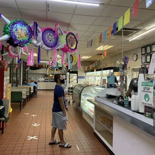  woman standing in a deli