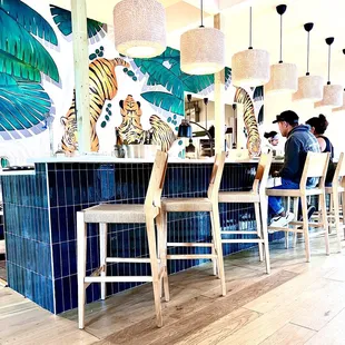 Clean aesthetic in the dining area that sits under the watchful eyes of the Tigres.