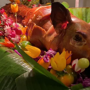 Premium garnished in a bed of banana leaves and seasonal fruits and vegetables.