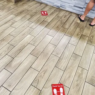  a woman standing on a tile floor