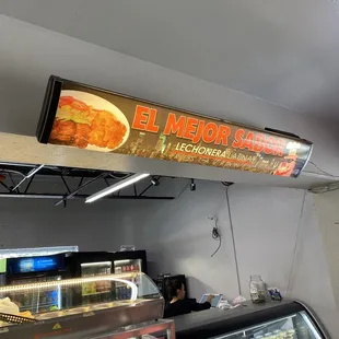 a sign above a deli counter