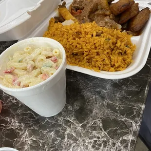 Pepper steak, rice with veggies, plantains, pasta salad
