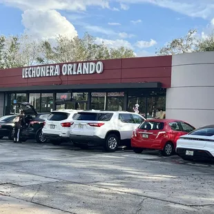 cars parked in front of a restaurant