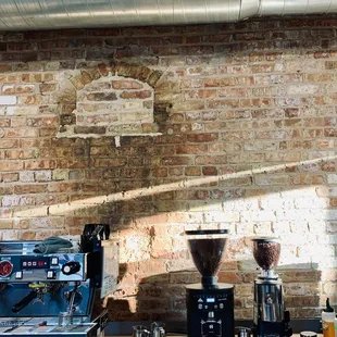 a brick wall with exposed pipes