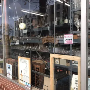 a store window with wine glasses