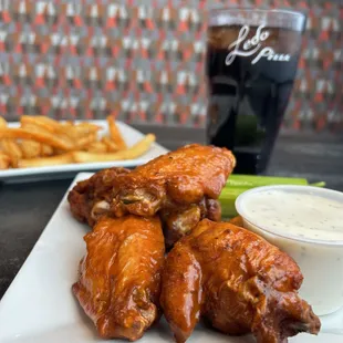 a plate of chicken wings and fries