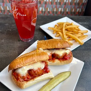 a sandwich and a pickle on a plate
