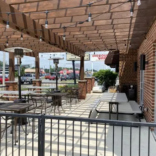 a patio with tables and chairs