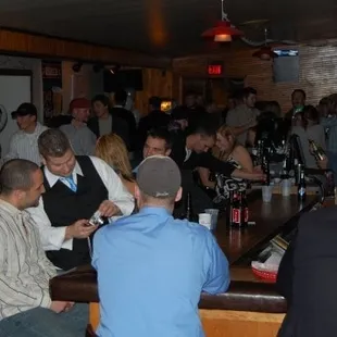 a large group of people sitting at a bar