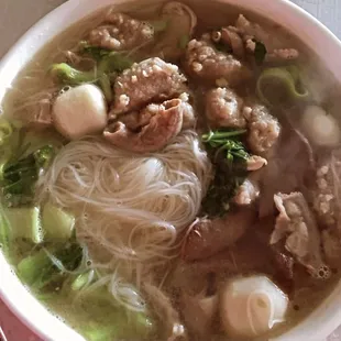 a bowl of soup with meat and noodles