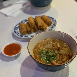 Mohinga (fish and rice noodle stew) and (in the back) samosa wrapped egg roll style
