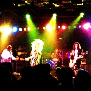 ows the band performing on stage