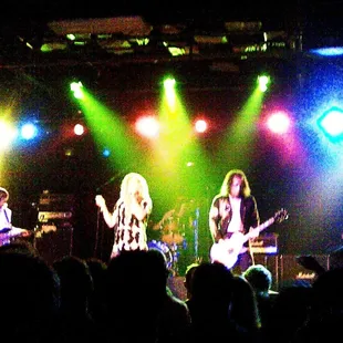 ows the band performing on stage