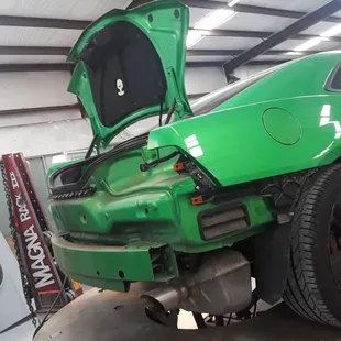 Repairs on this green Camaro