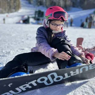 My kiddo strapping in for a run with me after her kids lesson session