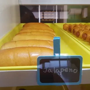 hot dogs in buns on trays