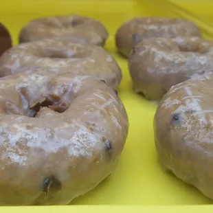 a variety of doughnuts on a yellow tray
