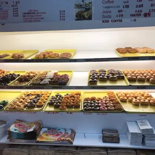 a variety of donuts in a display case