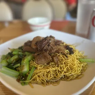 a plate of noodles and meat