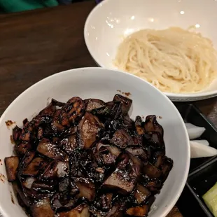 a bowl of noodles and a bowl of mushrooms