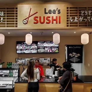 two women standing in front of the counter