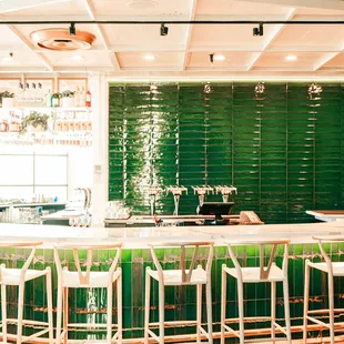 a bar with green tiles