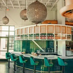 a bar with green chairs
