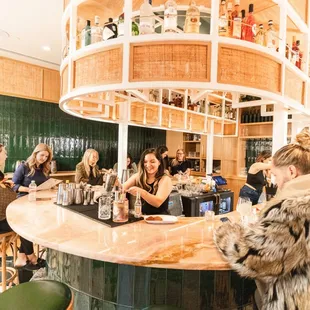 a group of women sitting at the bar