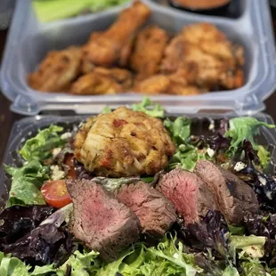 Steak Salad with a mini Crab Cake add-on and Old Bay wings in the back